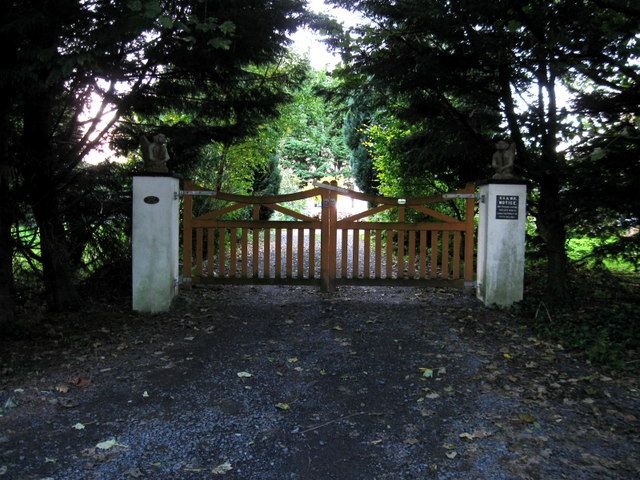 Timber double gates between white piers at the entrance to a house in Co Westmeath