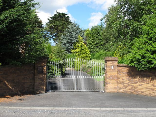 Metal gates across a tarmac drive near Lisnagry, Co Limerick